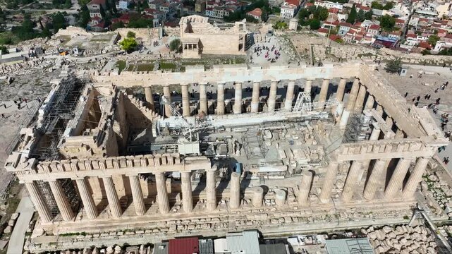 Aerial drone cinematic video of iconic Acropolis hill and the Parthenon a true ancient monument of Western Civilization with beautiful clouds, Athens historic center, Attica, Greece