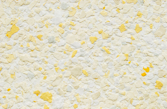 Light yellow decorative flakes wall texture or pattern as background	