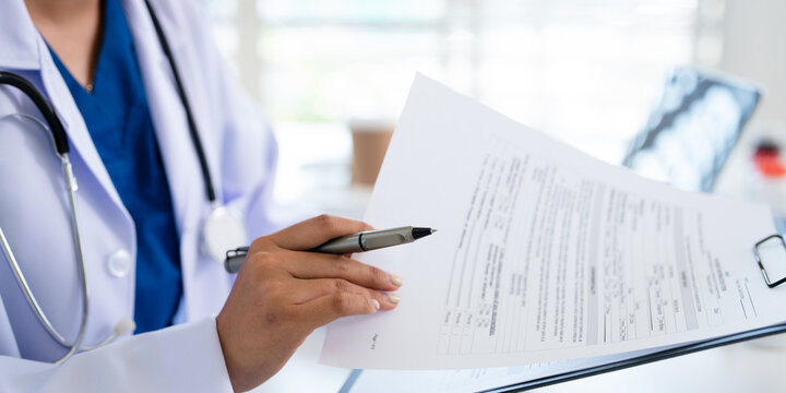 Healthcare, doctor woman in office, writing and clipboard with insurance, schedule and reading. Person, medical and professional with documents, GP with reports and paperwork