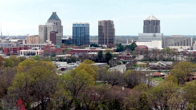 aerial pullout from greensboro north carolina skyline in spring