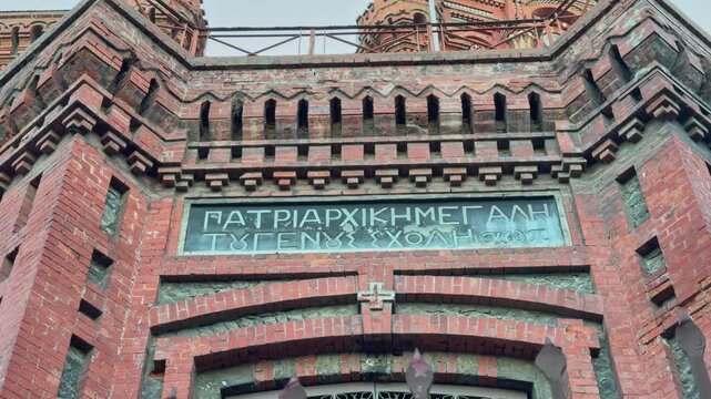 A low-angle, 4K cinematic footage captures the majestic structure of the historic Phanar Greek Orthodox College (&Phi;&alpha;&nu;&alpha;&rho;&iota;ώ&tau;&iota;&kappa;&eta; &Mu;&epsilon;&gamma;ά&lambda;&eta; &tau;&omicron;&upsilon; &Gamma;έ&nu;&omicron;&upsilon;&sigmaf; &Sigma;&chi;&omicron;&lambda;ή) in Istanbul, Turkey, often referred to as 'The Red