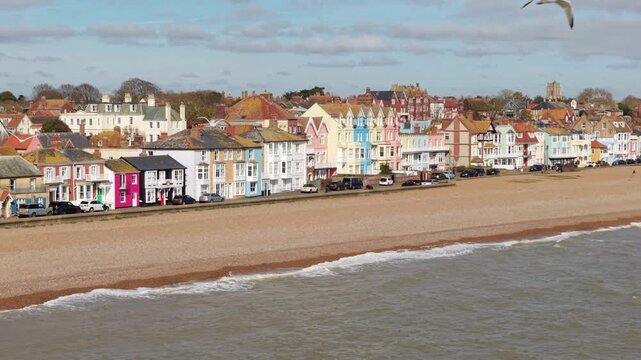 Aerial drone view of Aldeburgh seaside town featuring colourful houses and pebble beaches on the Suffolk coast UK