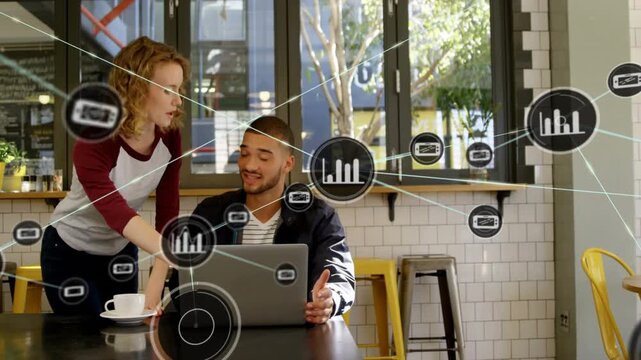 Woman placing cup leaning over laptop, pair reviewing business data with nodes expanding over them