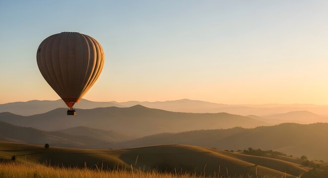 Majestic Hot Air Balloon Soars Over Rolling Hills at Sunrise with Golden Hues