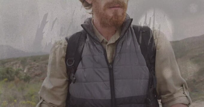 Hiker studying folded map, lifting head and scanning horizon, film-scratch overlay confirming route