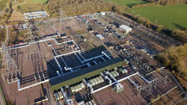 Close up aerial view of Bramford electrical substation near Ipswich, UK, showing high voltage transformers, busbars, and power line infrastructure.
