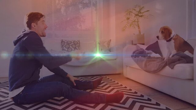 Owner on rug with treat calling dog, dog jumping down, lens-flare overlay passive for pet creators