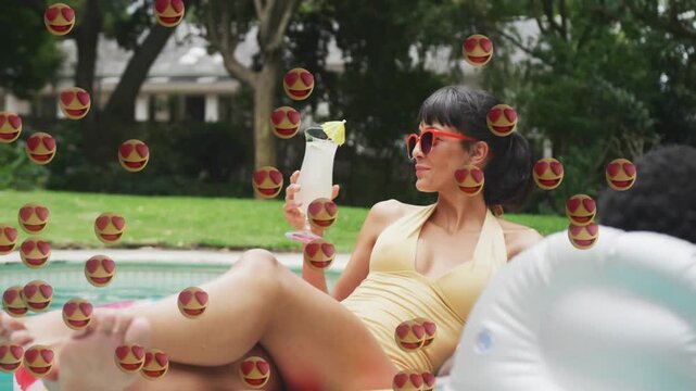 hearteyes emoji overlay entering left, woman relaxing on float sipping drink turning right, smiling