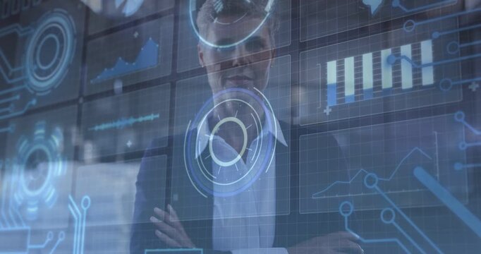 Female exec standing behind glass, automated HUD updating over torso and revealing business charts
