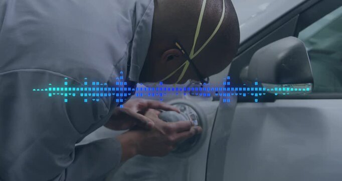 Auto tech pressing orbital sander on panel, guiding, smoothing paint while blue waveform overlaying