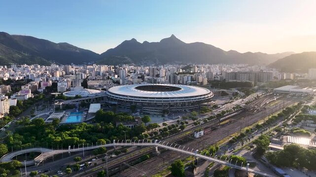 Sunset Maracana Stadium In Rio De Janeiro Brazil. Modern Football Stadium Overlooking A Dense Downtown City. Building Town Clouds Sky Illumination Downtown Panoramic. Rio de Janeiro Brazil.