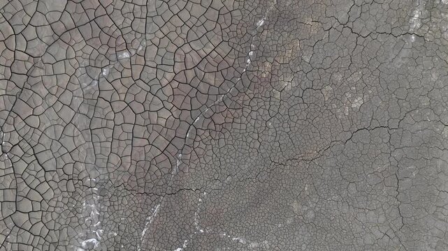 Aerial view of the intricate patterns of cracked dry earth and mineral deposits in the mining landscape of Minas de Riotinto, Andalusia, Spain.