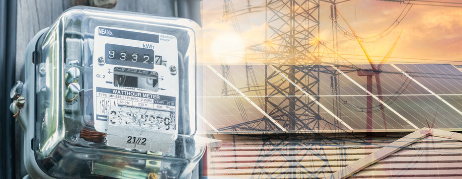Watt hour meter on rooftop solar, wind turbine, and electric pylon background. Sustainable energy. Solar and wind power. Renewable energy. Energy crisis. Carbon neutrality. Sustainable resources.