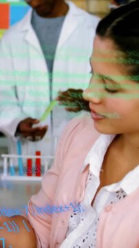 Vertical video: Camera panning student holding sample as peer handling tube, overlays aiding class