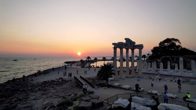Side Ancient City extends along a Mediterranean peninsula where the temples of Apollo and Athena, Roman theater and ancient harbor define a layered coastal landscape in Antalya, T&uuml;rkiye.