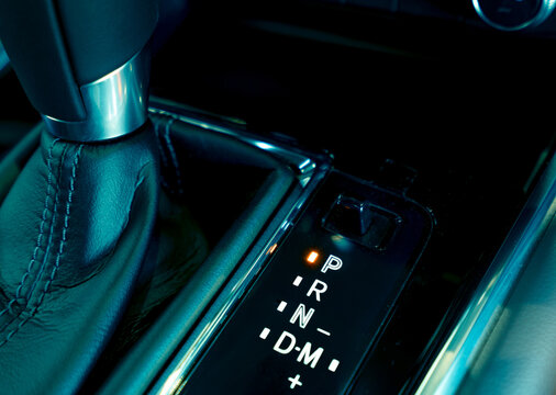 Automatic car gear stick. Automatic transmission gear shift inside modern and sport design car. Gear stick shift on parking mode position. Park-transmission locked in position for parking. Automotive.