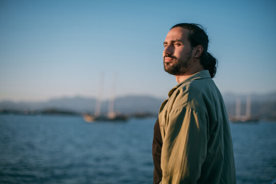 Portrait of a young man on a boat trip on a small ship in the sea on a sunny day.