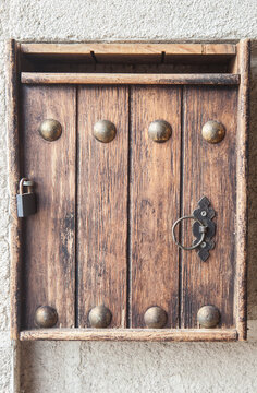 Wooden mailbox placed on the inner jamb of the door of a rural house