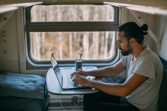 Man with laptop on the train.