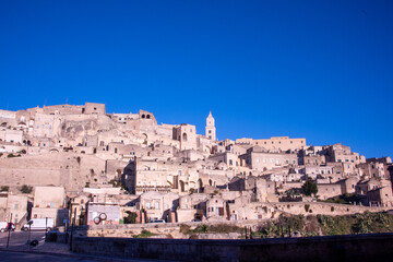 Obraz premium Carved into stone and shaped by centuries, Matera rises from the rocks of southern Italy like a timeless masterpiece. 