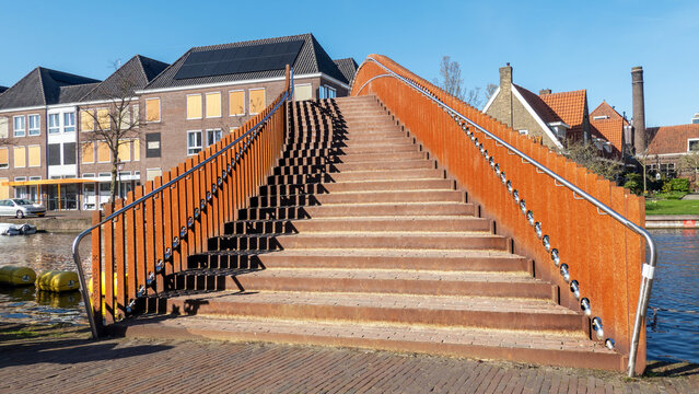 Iron footbridge crossing river Rhine in Leiden (Netherlands); it is part of Singel (canal) park, a 6.5km circular green pedestrian route around the historic centre of Leiden. 