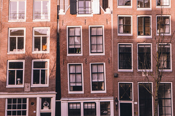 Obraz premium Traditional leaning brick houses with large windows in Amsterdam