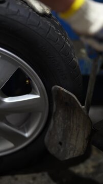 A tire machine dismounting a tire from a car rim.

