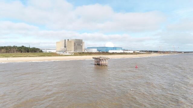 Aerial drone view of Sizewell B and C nuclear power station from the sea with offshore platform