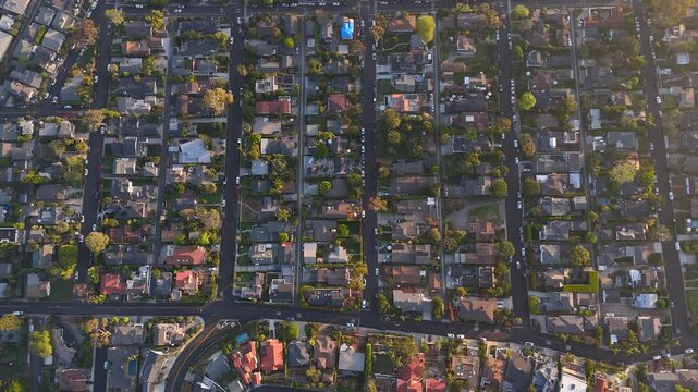 Aerial view of houses in a dense urban neighborhood with streets and trees creating a textured tapestry, Laguna Beach, California, United States.