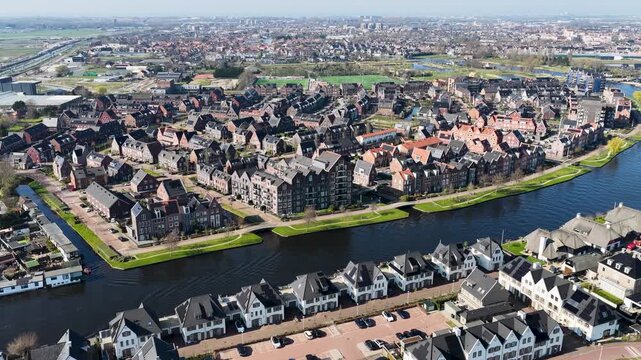 Aerial of Dutch houses nearby Leiden, Netherlands with the river Rijn.