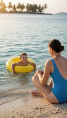 Obraz premium Mother watching young boy in yellow inflatable ring at tropical beach. Water safety scene with calm ocean waves, palm trees, and golden hour sunlight during family vacation