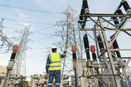 Engineer uses a thermal camera to inspect high voltage switchyard equipment, supporting condition monitoring, preventive maintenance, operational safety, and grid reliability.