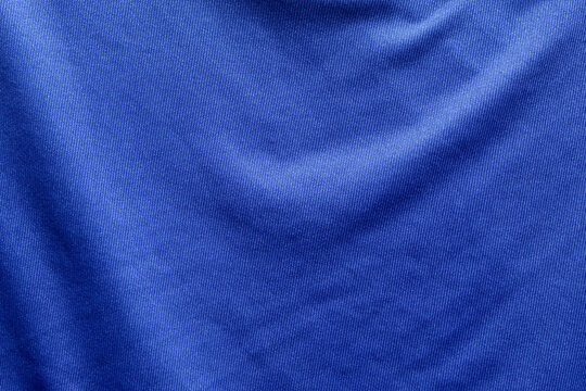 Dark blue polyester fabric texture with microfiber details and soft pleats