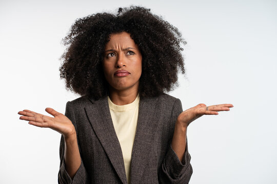 confident young businesswoman shrugging shoulders in office, doubtful professional woman making unsure gesture, confused businesswoman raising hands isolated on white background 