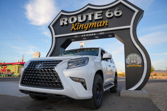 Kingman, Arizona - March 28, 2026: A Lexus GX 460 SUV drives through the Route 66 sign in Kingman Arizona