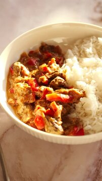 Classic Beef featuring tender beef, vibrant red peppers, and a rich creamy sauce served with fluffy white rice
