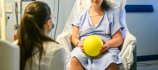 Female patient with physiotherapy person doing some rehabilitation in professional clinic.