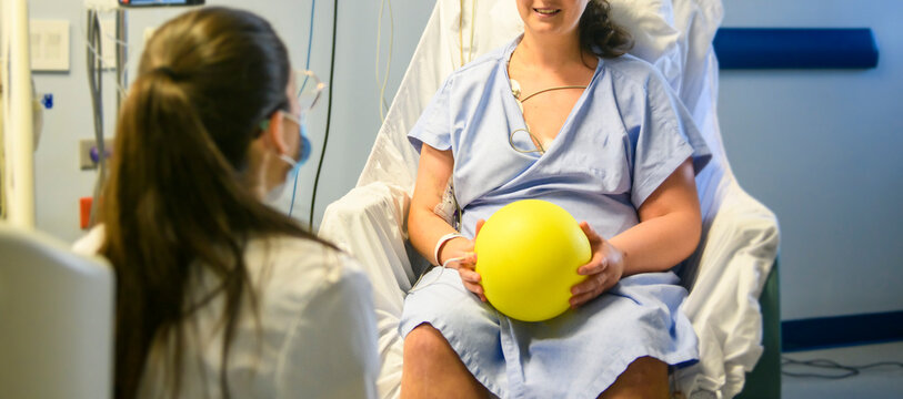 Female patient with physiotherapy person doing some rehabilitation in professional clinic.