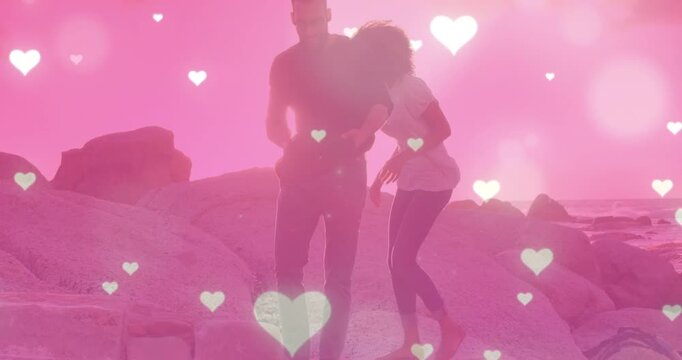 Animation of heart icons over couple at beach