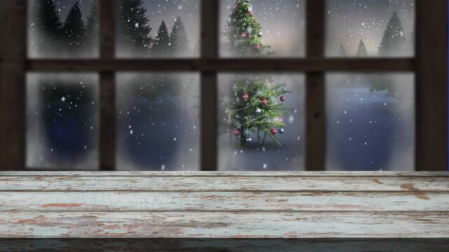 Animation of snow falling over christmas tree and winter scenery seen through window
