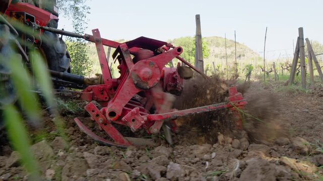 Tractor plows the land for the cultivation of vineyards in the countryside