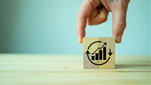 Business growth concept with upward trending graph and cycle arrows on wooden blocks