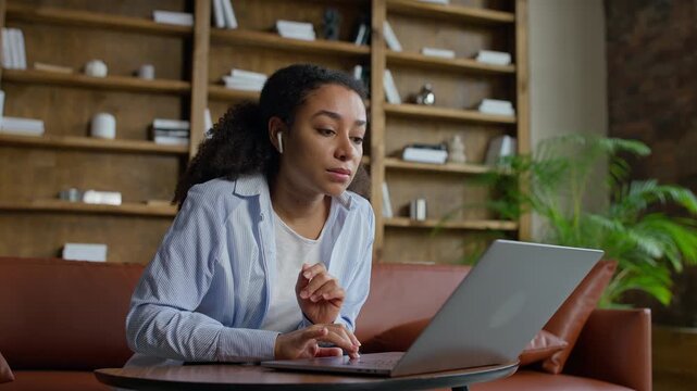 Stressed woman reading bad news on laptop