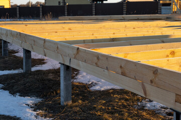 Pile foundation for timber frame house, base beams, mounting stage, site construction, first phase...