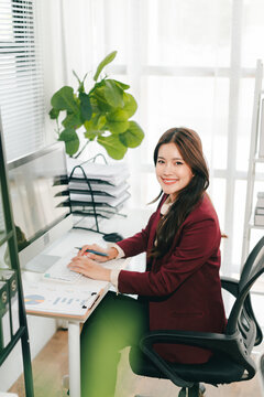 Young Asian woman doing financial accounting and taxes for a company Organizing account analysis reports Investment information Financial and tax system concepts