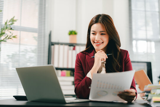 The female employees are working and searching for documents. The female accountant is preparing the company's annual taxes.