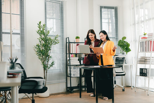 Young colleagues discussing business and price chart analyzes business people on the table great in modern coworking office teamwork concept. Calculate personal tax for customers