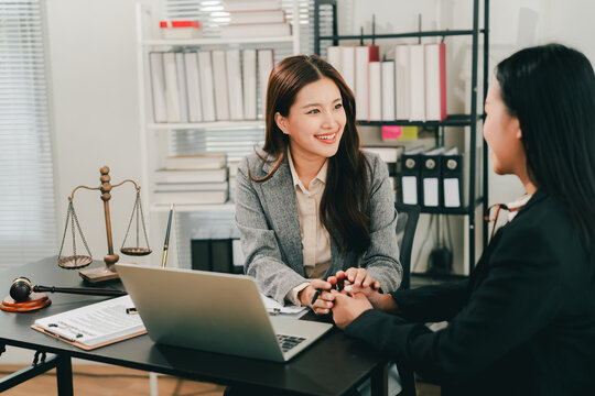 concept of justice and law A male judge in the courtroom on a wooden table and a male counselor or lawyer working in the office. Law, advice and justice concepts.