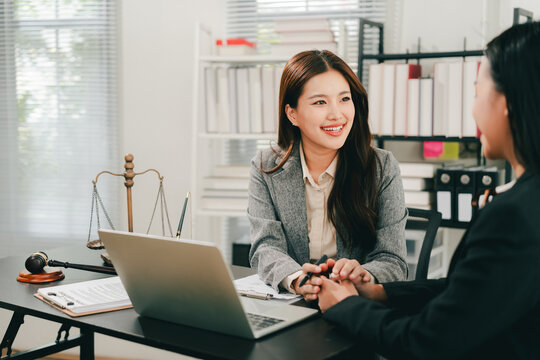 concept of justice and law A male judge in the courtroom on a wooden table and a male counselor or lawyer working in the office. Law, advice and justice concepts.