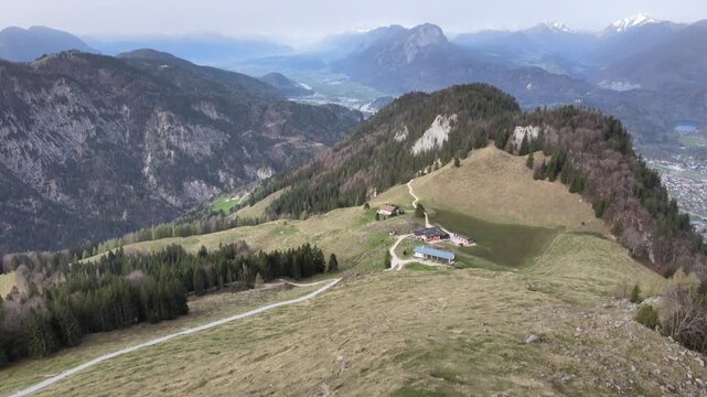 Aerial drone footage of panoramic mountain landscape with alpine meadow and foothills view